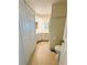 This bathroom features neutral tile, a sink with vanity, and towel hooks at 139 Royal Palm Dr, Leesburg, FL 34748