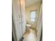 Bathroom featuring tile floors, toilet, shower/tub combo, and linen storage cabinet at 139 Royal Palm Dr, Leesburg, FL 34748