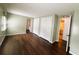 Bedroom featuring wood floors and view of the closets and ensuite bathroom at 139 Royal Palm Dr, Leesburg, FL 34748