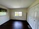 Bedroom featuring hardwood floors, multiple windows and spacious closet at 139 Royal Palm Dr, Leesburg, FL 34748