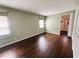 Bedroom featuring wood floors, light green walls, and bright windows at 139 Royal Palm Dr, Leesburg, FL 34748