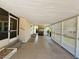 Under carport showing screened porch with steps and front door at 139 Royal Palm Dr, Leesburg, FL 34748