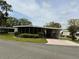 Charming single-story home with a carport, screened porch, and nicely landscaped front yard at 139 Royal Palm Dr, Leesburg, FL 34748