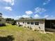 Exterior of home shows landscaped yard with well-kept lawn and pleasing architectural details at 139 Royal Palm Dr, Leesburg, FL 34748