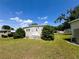 Welcoming front yard with a quaint porch, complemented by well-manicured lawn and established greenery at 139 Royal Palm Dr, Leesburg, FL 34748