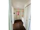 Hallway with hardwood floors, door to outside, and built-in vanity in white at 139 Royal Palm Dr, Leesburg, FL 34748