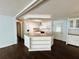 Open kitchen with white cabinets, appliances, and an island at 139 Royal Palm Dr, Leesburg, FL 34748