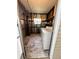 Laundry room with washer, dryer, window, shelves, and metal walls at 139 Royal Palm Dr, Leesburg, FL 34748