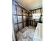 Functional laundry area features durable flooring, washer, dryer hookups, and space-saving shelving at 139 Royal Palm Dr, Leesburg, FL 34748