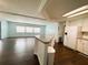 View of living room and kitchen featuring hardwood floors and white kitchen cabinets at 139 Royal Palm Dr, Leesburg, FL 34748