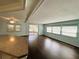 Bright living room featuring wood-look flooring, ceiling fan, and sliding glass doors at 139 Royal Palm Dr, Leesburg, FL 34748