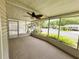 Inviting screened porch with a ceiling fan, offering a relaxing outdoor space and community views at 139 Royal Palm Dr, Leesburg, FL 34748