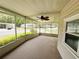 Spacious screened porch with ceiling fan and views of the landscaped community at 139 Royal Palm Dr, Leesburg, FL 34748
