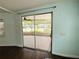 View through sliding glass doors to a screened in porch at 139 Royal Palm Dr, Leesburg, FL 34748