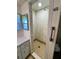 Corner shower stall with tile walls and floor in bathroom at 139 Royal Palm Dr, Leesburg, FL 34748