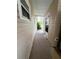 Outdoor walkway between houses with neutral siding at 139 Royal Palm Dr, Leesburg, FL 34748