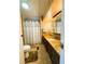 Bathroom with standing shower, tile floor, dark wood cabinet, and countertop at 141 Aspen Cir, Leesburg, FL 34748