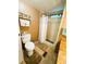 Bathroom with standing shower, tile floor, dark wood cabinet, and countertop at 141 Aspen Cir, Leesburg, FL 34748