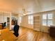 Bright bedroom with laminate flooring, ceiling fan, closet, and shelving near shuttered windows at 141 Aspen Cir, Leesburg, FL 34748
