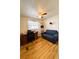 Bedroom area with wood laminate floor, work desk, and comfortable sofa at 141 Aspen Cir, Leesburg, FL 34748