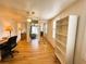 Bright bedroom with laminate flooring, ceiling fan, closet, and shelving near shuttered windows at 141 Aspen Cir, Leesburg, FL 34748