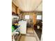 Functional laundry room featuring a washer, storage shelves, and neatly organized cleaning supplies at 141 Aspen Cir, Leesburg, FL 34748