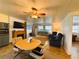 Comfortable living room features wood-look floors, furnishings, fireplace, and access to sunroom at 141 Aspen Cir, Leesburg, FL 34748
