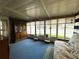 Bright sunroom with large windows, blue carpet, hutch, and plenty of light at 141 Aspen Cir, Leesburg, FL 34748