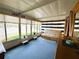Inviting sunroom with blue carpet, natural light, furnishings, and privacy shades at 141 Aspen Cir, Leesburg, FL 34748