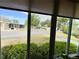Neighborhood street view from sunroom window with window shades at 141 Aspen Cir, Leesburg, FL 34748