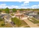 Aerial view of the home, highlighting the driveway, garage, and landscaped front yard in a residential neighborhood at 144 Pinewood Cir, Kissimmee, FL 34743