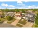Birds eye view of the house, featuring a spacious yard, driveway, solar panels, and a friendly neighborhood at 144 Pinewood Cir, Kissimmee, FL 34743