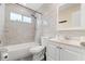 Updated bathroom featuring tub, shower, modern vanity, updated tile, and white fixtures at 144 Pinewood Cir, Kissimmee, FL 34743