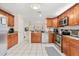 Spacious kitchen with wooden cabinets, stainless steel appliances, granite countertops, and ample counter space at 144 Pinewood Cir, Kissimmee, FL 34743