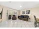 Bright living room with bay window, tile flooring, and comfortable seating at 144 Pinewood Cir, Kissimmee, FL 34743