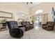 Spacious living room featuring tile floors, plush seating, and sliding glass doors to the pool at 144 Pinewood Cir, Kissimmee, FL 34743