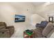 Cozy living room featuring plush seating, a large TV, and neutral walls at 144 Pinewood Cir, Kissimmee, FL 34743