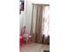 Bright bedroom with a small pink vanity table at 1484 Avleigh Se Cir, Orlando, FL 32824
