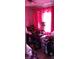 Cluttered bedroom with pink curtains and a ceiling fan at 1484 Avleigh Se Cir, Orlando, FL 32824