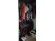 A filled closet with hanging clothes and a storage basket at 1484 Avleigh Se Cir, Orlando, FL 32824