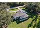 Aerial view of beautiful home with screened pool, lush green lawn, and mature trees at 15373 Evans Ranch Rd, Lakeland, FL 33809