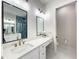 Stylish bathroom with quartz counters, modern vanity lighting, and glass shower at 15373 Evans Ranch Rd, Lakeland, FL 33809