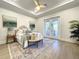 Comfortable bedroom featuring tray ceilings, french doors to the lanai, and a cozy sitting area with rug at 15373 Evans Ranch Rd, Lakeland, FL 33809