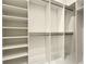 Spacious walk-in closet featuring custom shelving and ample storage, providing organization and style at 15373 Evans Ranch Rd, Lakeland, FL 33809