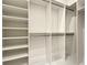 Walk-in closet with custom shelving and hanging rods for organized storage at 15373 Evans Ranch Rd, Lakeland, FL 33809