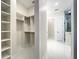 Open walk-in closet leads to modern bathroom with glass enclosed shower at 15373 Evans Ranch Rd, Lakeland, FL 33809