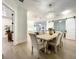 Bright dining area with chandelier and slider doors to other rooms, open to kitchen at 15373 Evans Ranch Rd, Lakeland, FL 33809