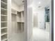 Hallway view leading to a stylish bathroom with a glass-enclosed shower and custom closet at 15373 Evans Ranch Rd, Lakeland, FL 33809