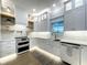 Elegant white kitchen featuring farmhouse sink, modern appliances, and stylish backsplash at 15373 Evans Ranch Rd, Lakeland, FL 33809