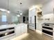 Bright kitchen featuring white cabinets, a large island, pendant lighting and stainless steel appliances at 15373 Evans Ranch Rd, Lakeland, FL 33809